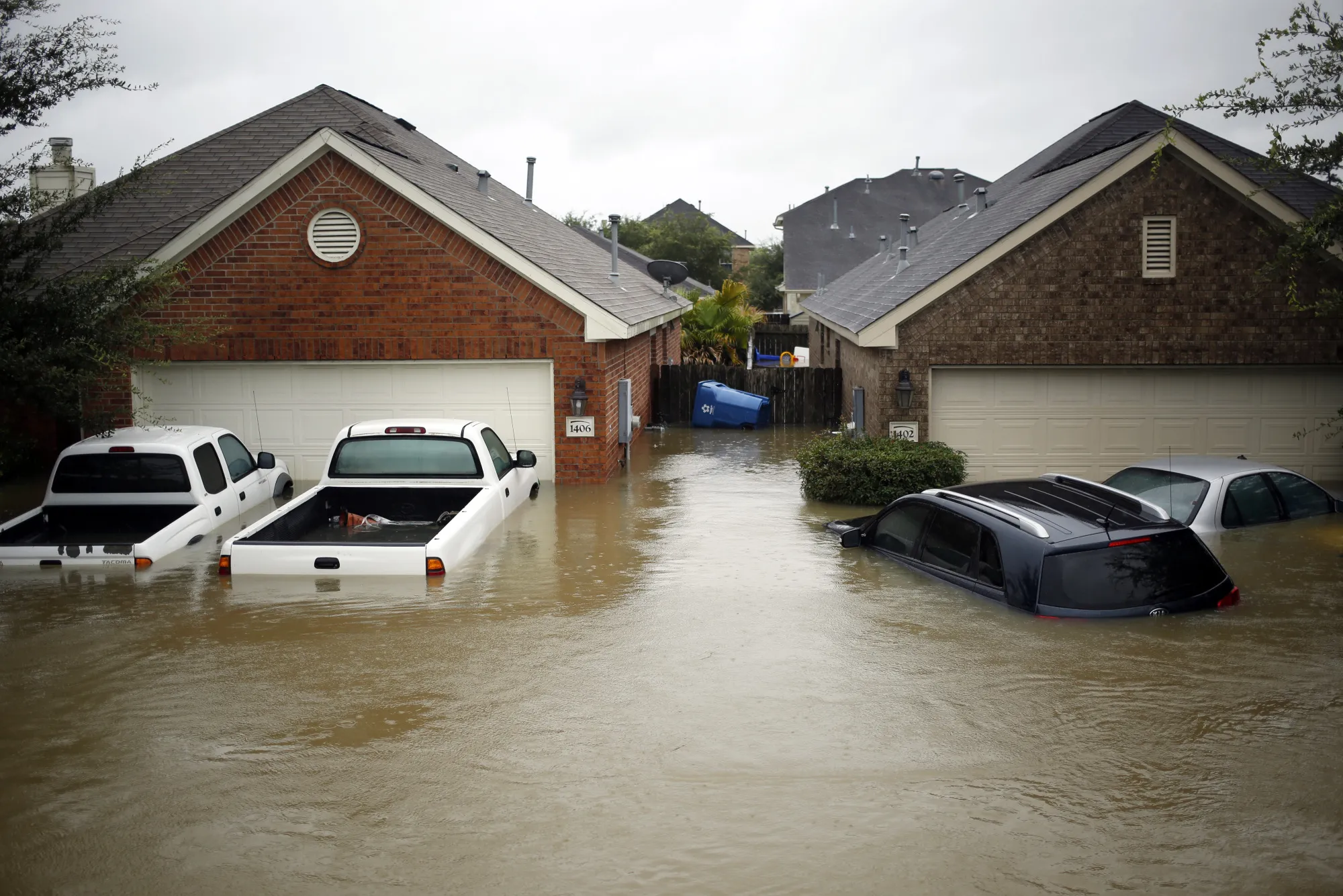 Houses and vehicles&nbsp;stand in floodwaters due to Hurricane Harvey in Spring, Texas, on Aug. 28.