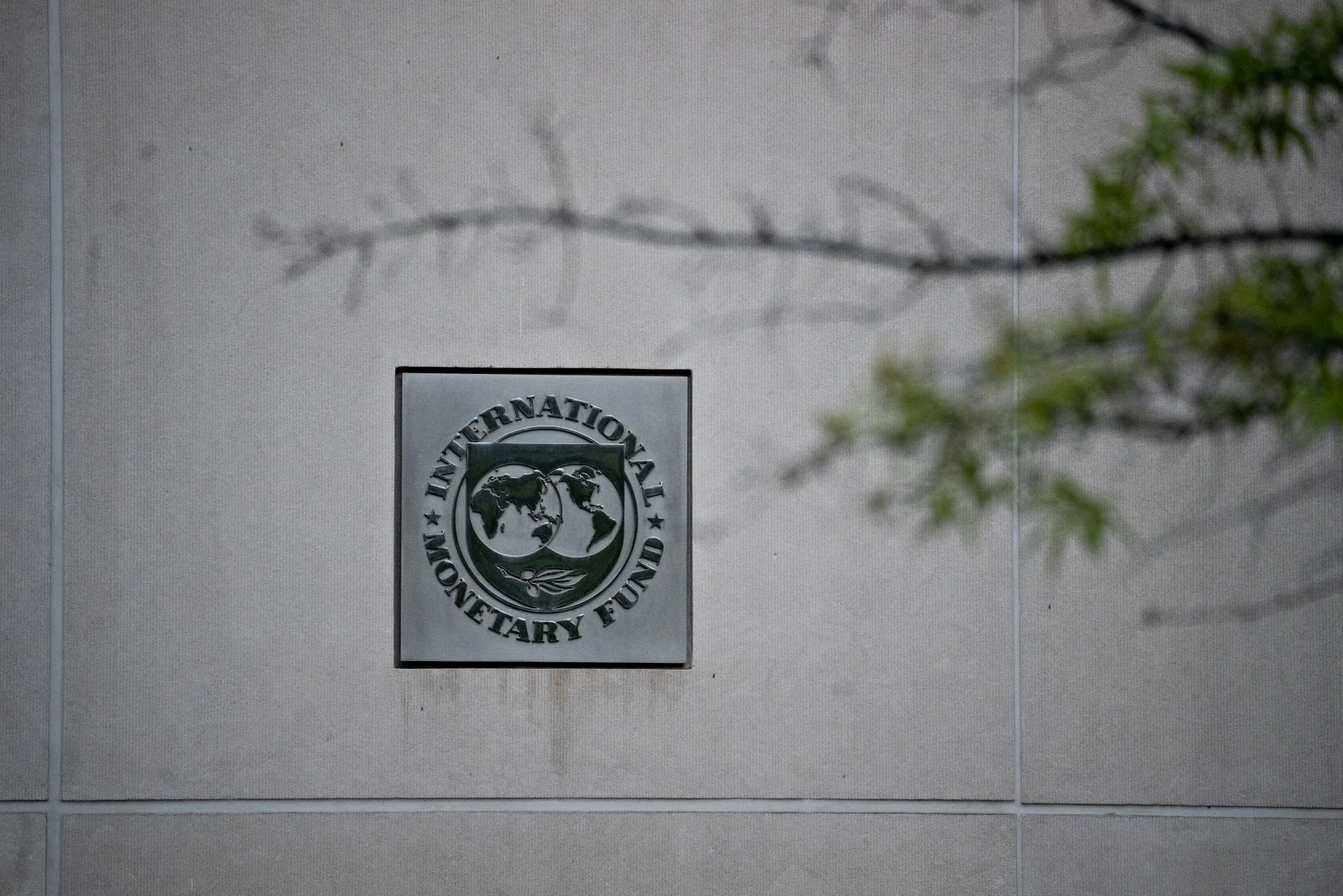 Signage hangs at the International Monetary Fund headquarters in Washington, D.C.