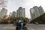A motorist moves past the Riviera Garden residential property, developed by Shimao Group Holdings Ltd.,&nbsp;in Shanghai.