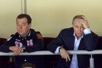 Russian President Vladimir Putin (right) and Prime Minister Dmitry Medvedev (left) watch the Russia vs Slovakia ice hockey match at the 2014 Winter Olympics on Feb. 16 in Sochi