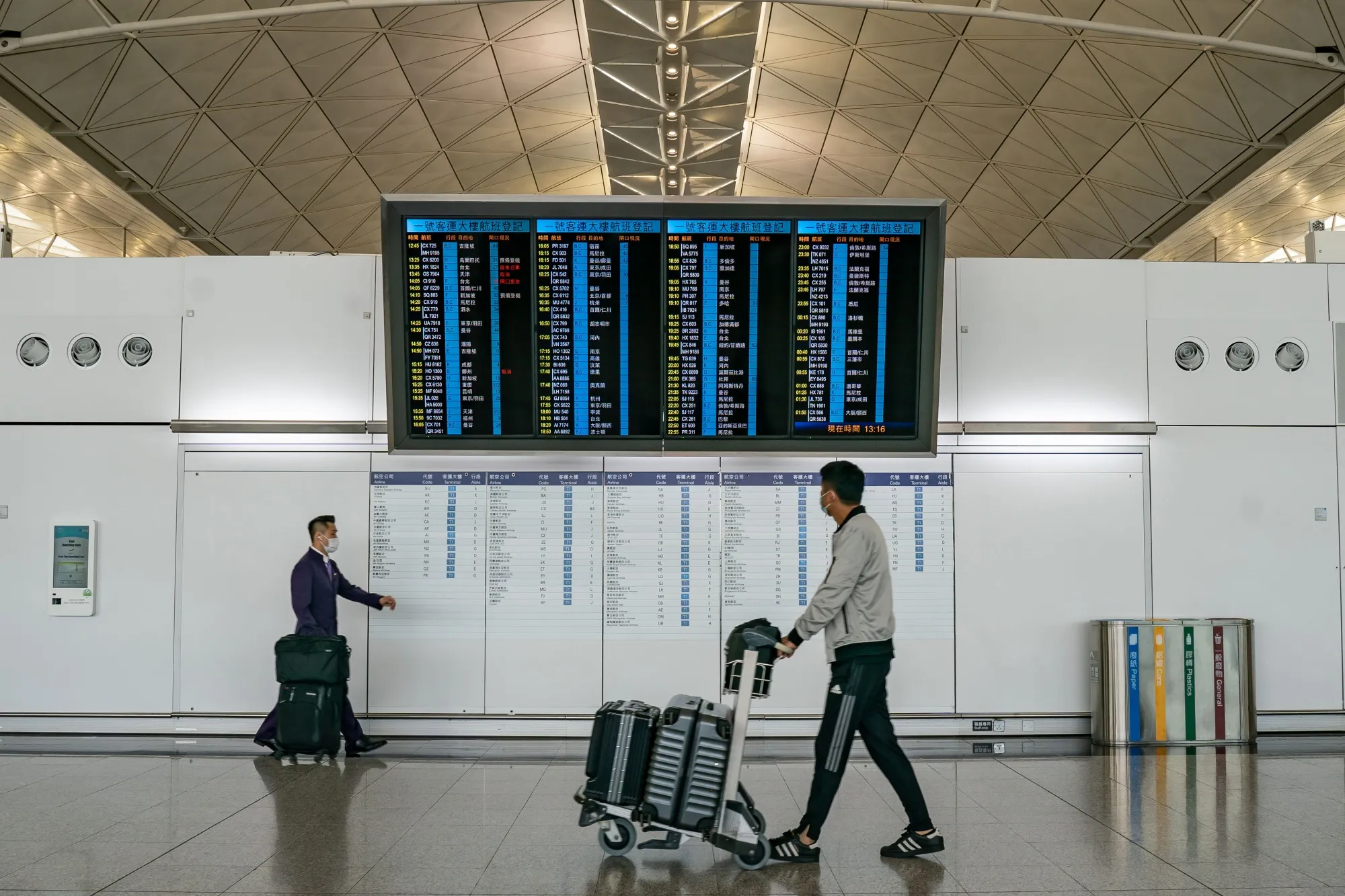 Travellers in the departure hall of the Hong Kong International Airport on December 30.&nbsp;