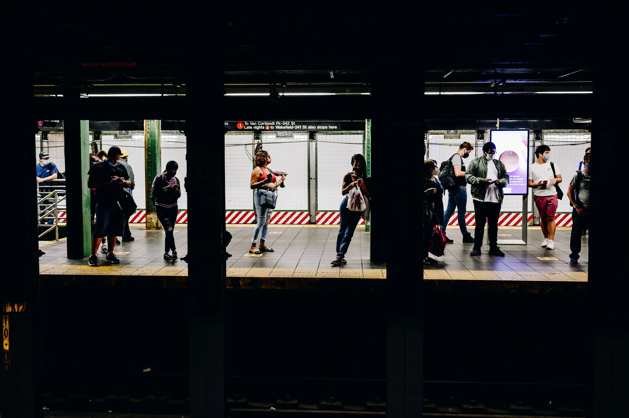 Subway riders wait on a&nbsp;platform at Times Square in New York.