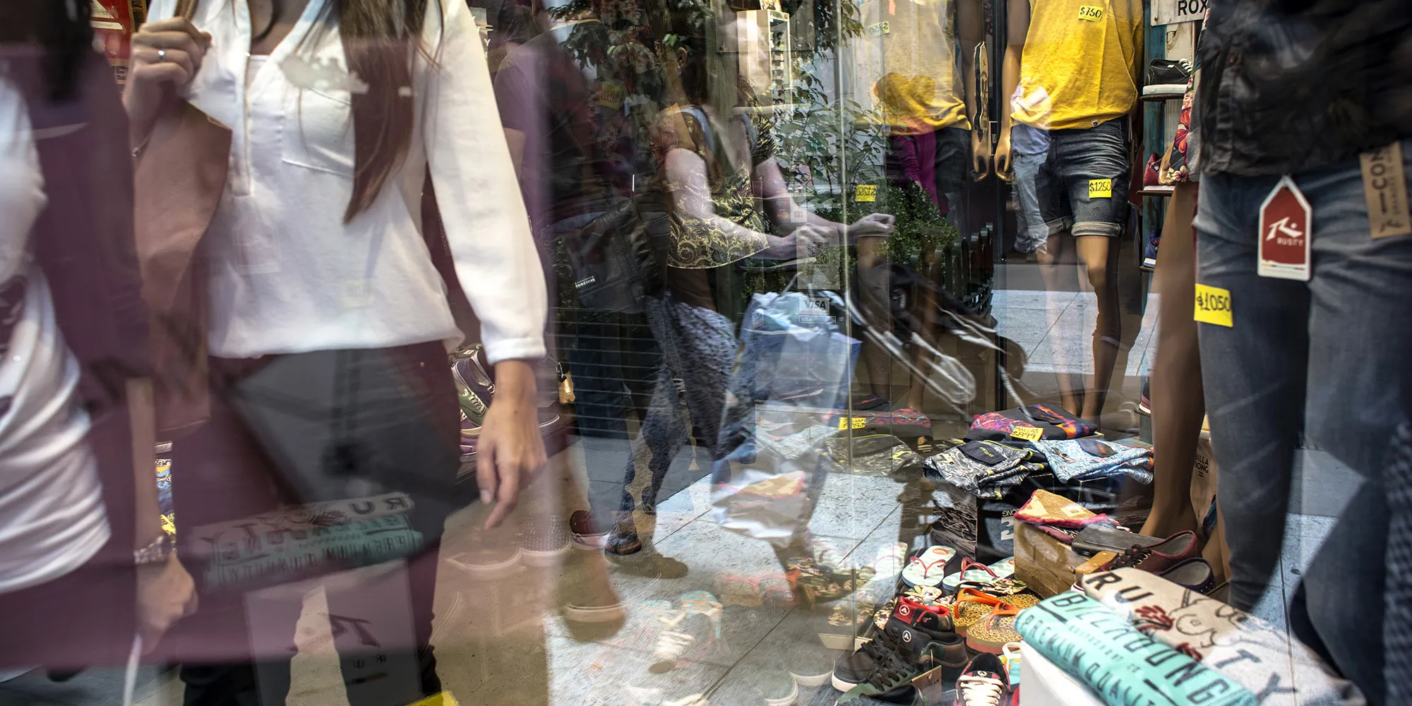 Pedestrians are reflected in the window of a&nbsp;store on Florida Street in Buenos Aires.&nbsp;