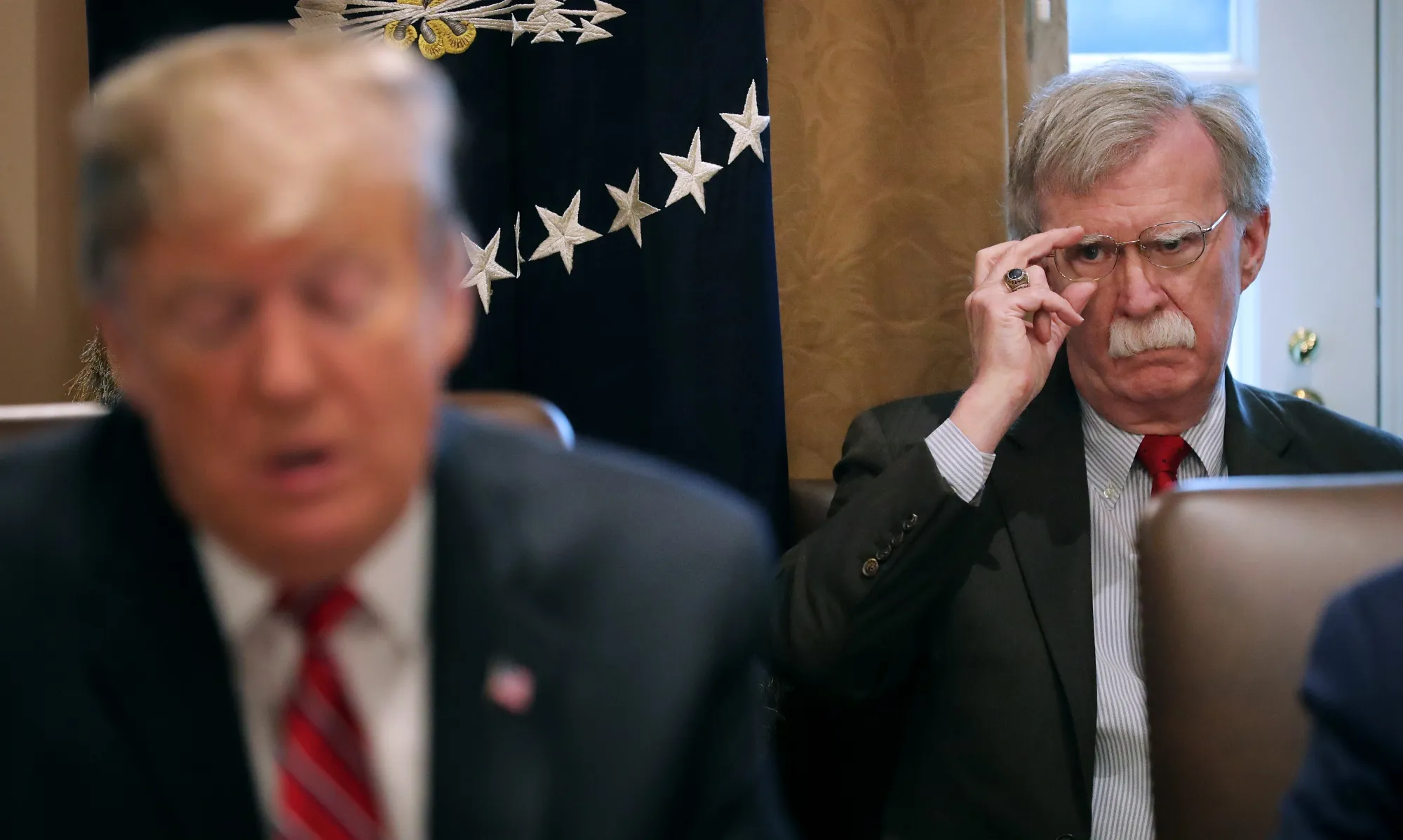 John Bolton listens to&nbsp;Donald Trump&nbsp;during a meeting&nbsp;in Washington on Feb. 12.