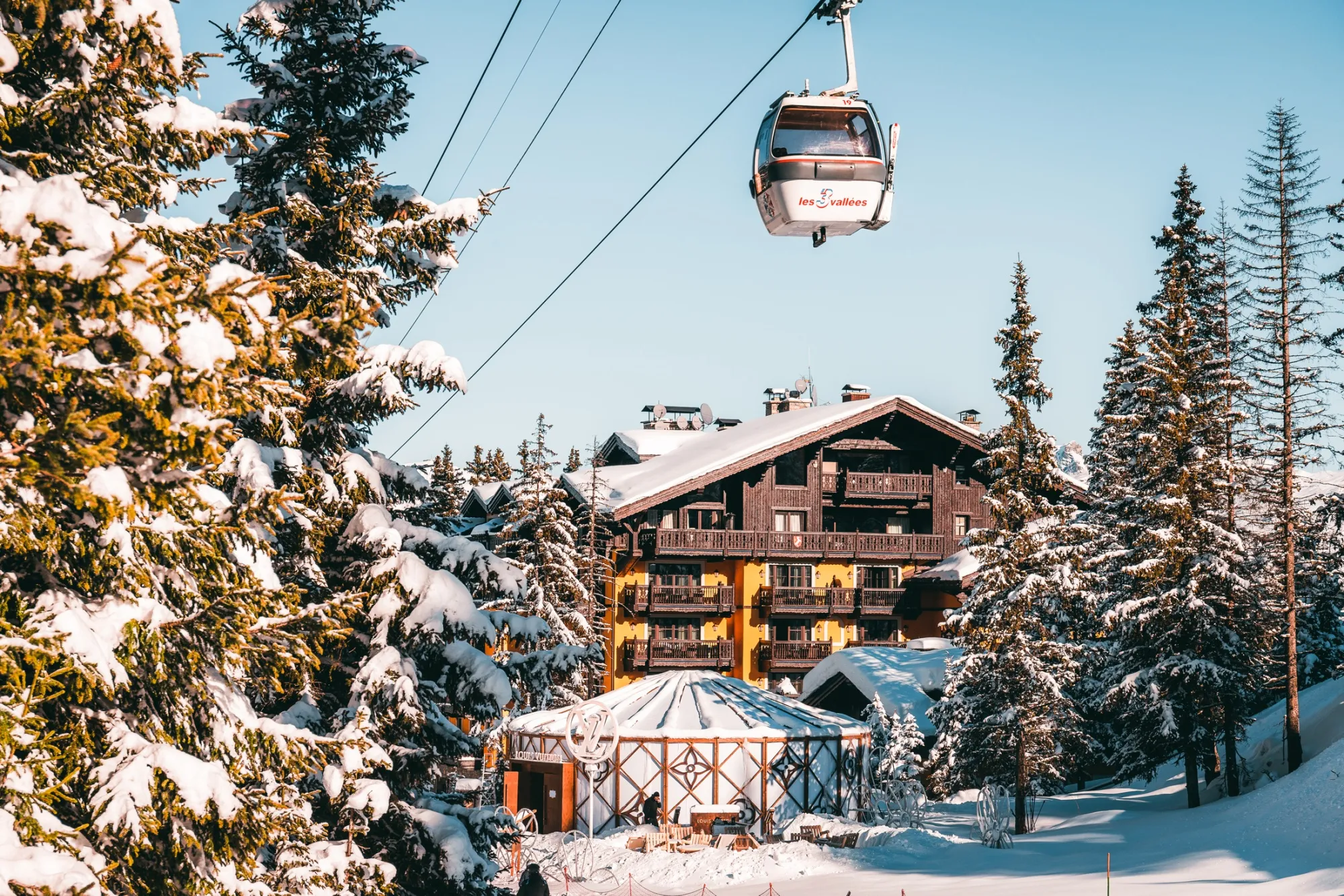 A cable car climbs past Courchevel 1850.