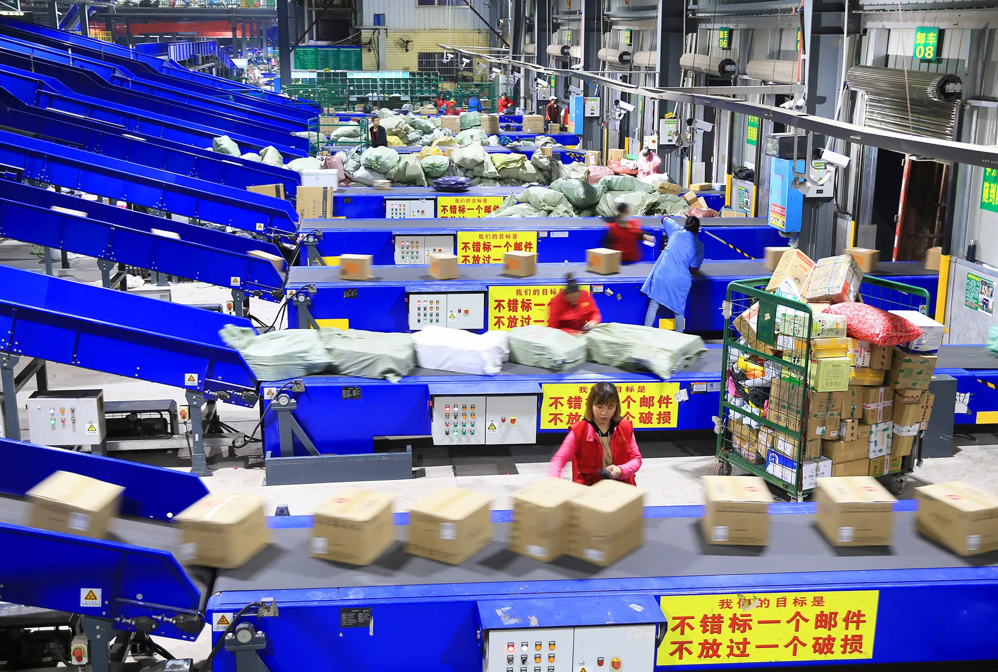Employees sort out parcels at a logistics base of China Post during&nbsp;Singles' Day.