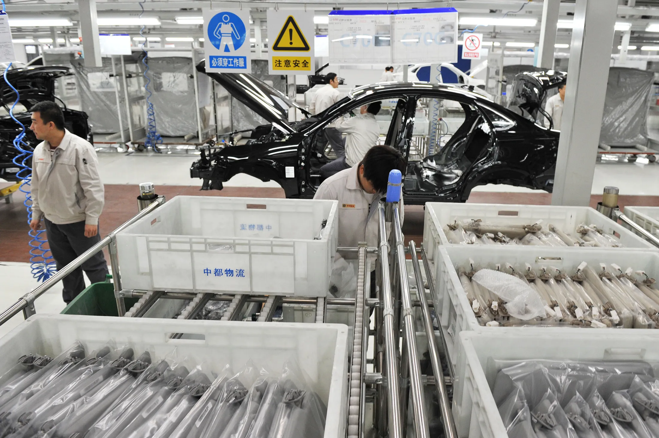 Employees work on the production line at the BAIC Motor Corporation facility in Beijing, China, on Nov. 6, 2014.
