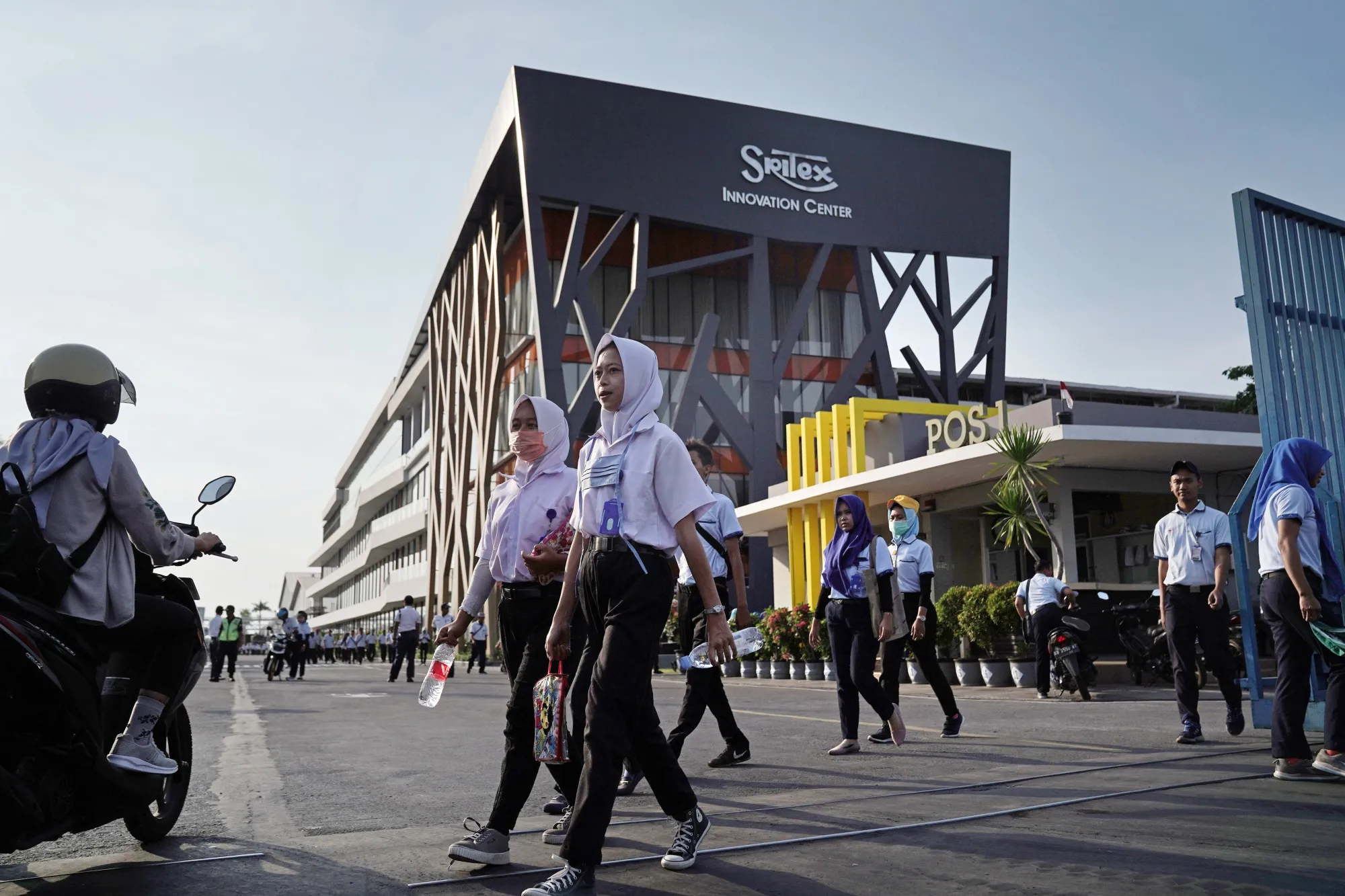 Workers exit the Sri Rejeki Isman PT factory in Solo, Central Java, Indonesia.