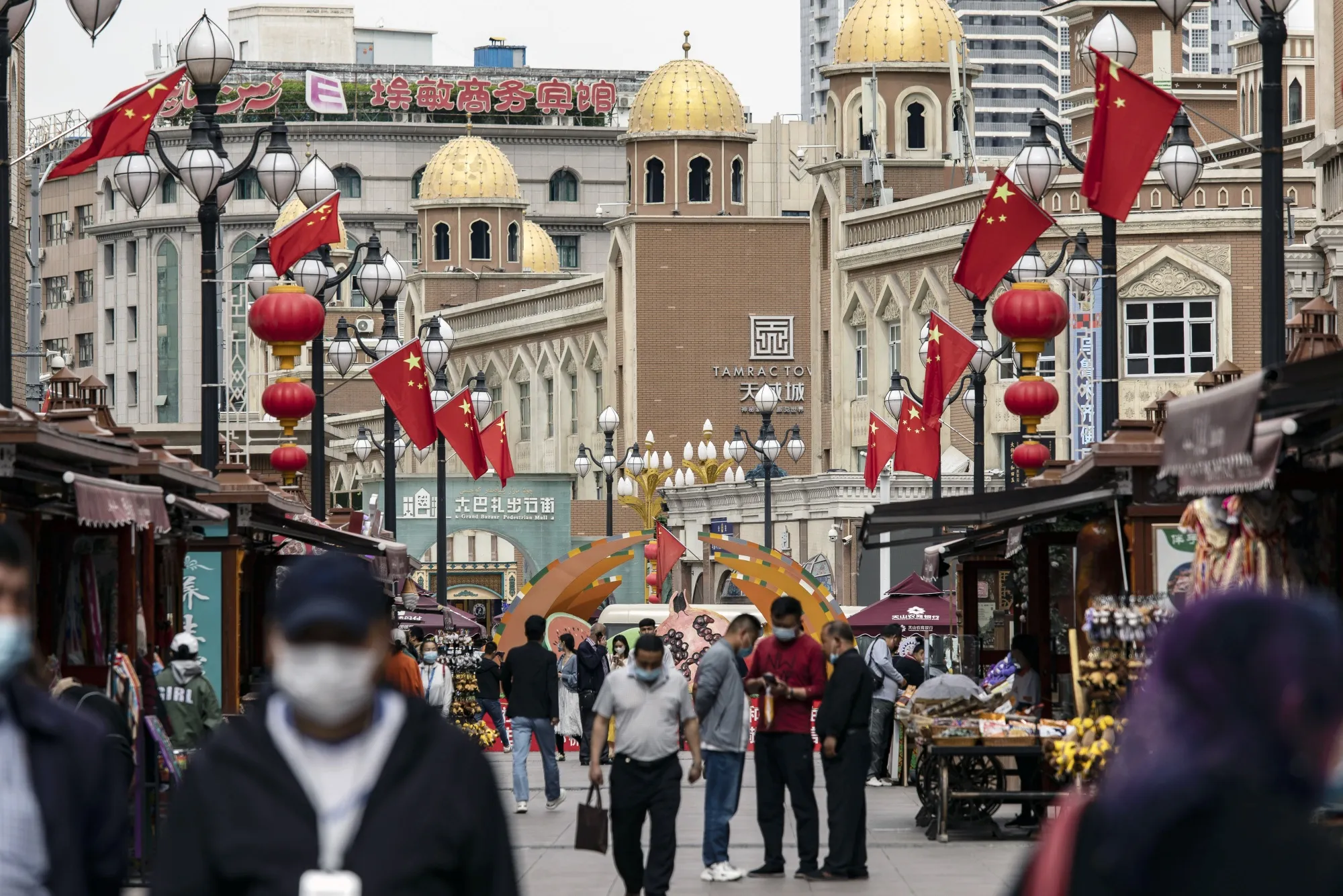 Pedestrians at the Xinjiang International Grand Bazaar in Urumqi, Xinjiang province.