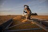 A farmer uses a shovel to move corn inside a semi trailer during a harvest in Buda, Illinois, U.S., on Tuesday, Nov. 5, 2019. Wheat and corn futures were declining as lackluster U.S. export sales underscored concerns about abundant global grain supplies.