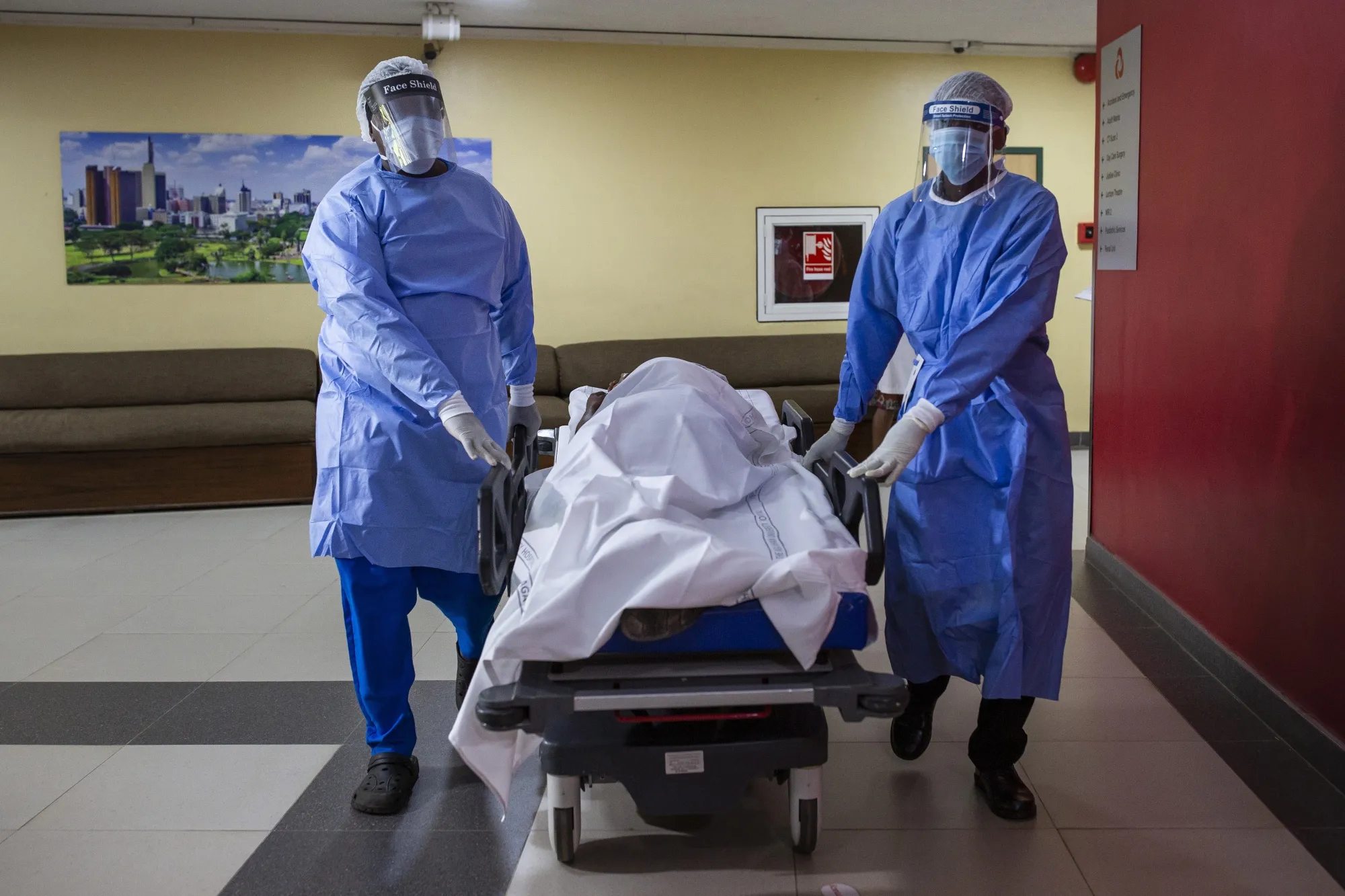 Medical workers wearing protective gear (PPE) push a trolley with a simulated patient during a mass patient influx drill at the Aga Khan University Hospital in Nairobi, on April 9.