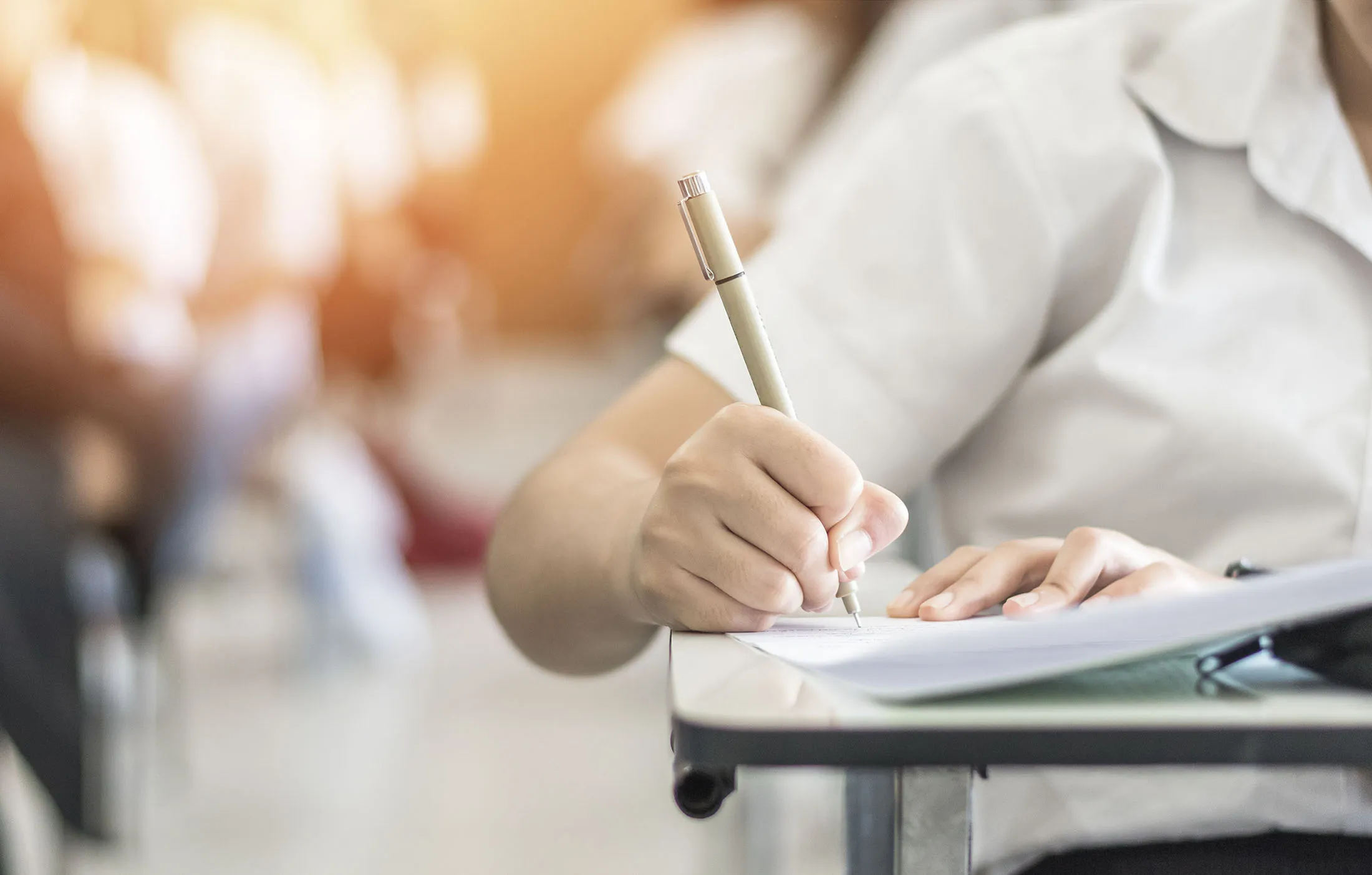 Exam with school student having a educational test, thinking hard, writing answer in classroom for  university education admission and world literacy day concept