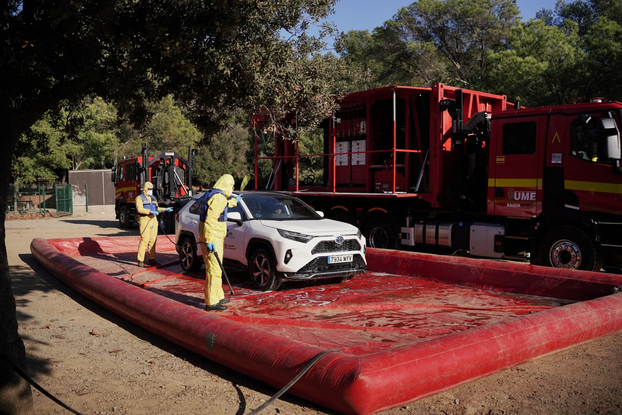 Spanish military personnel carry out protective decontamination of vehicles near Cerdanyola del Valles, on Dec. 3.