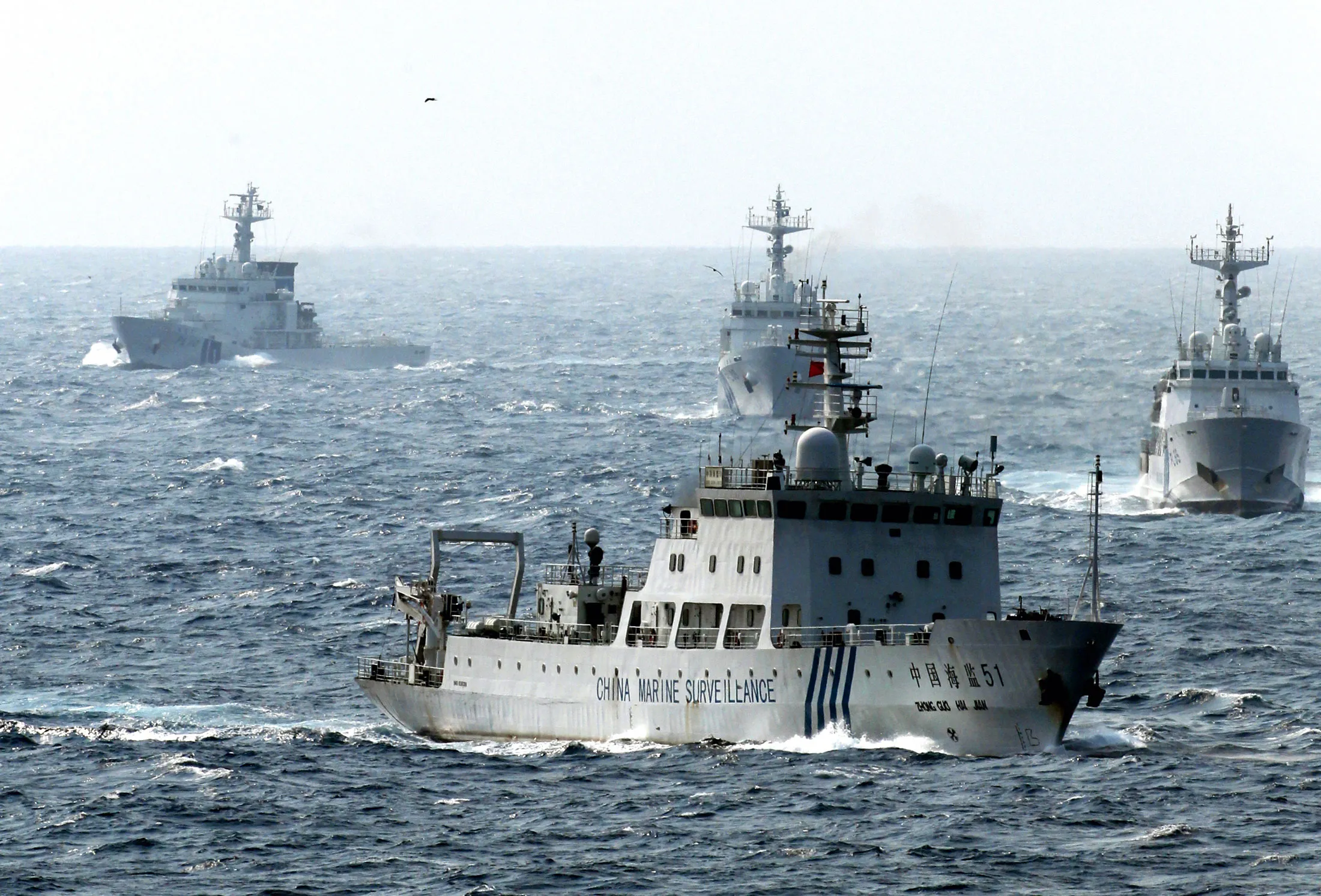 A China Marine Surveillance vessel, foreground, cruises with Japan Coast Guard ships near the near the disputed Senkaku Islands on April 23, 2013.

