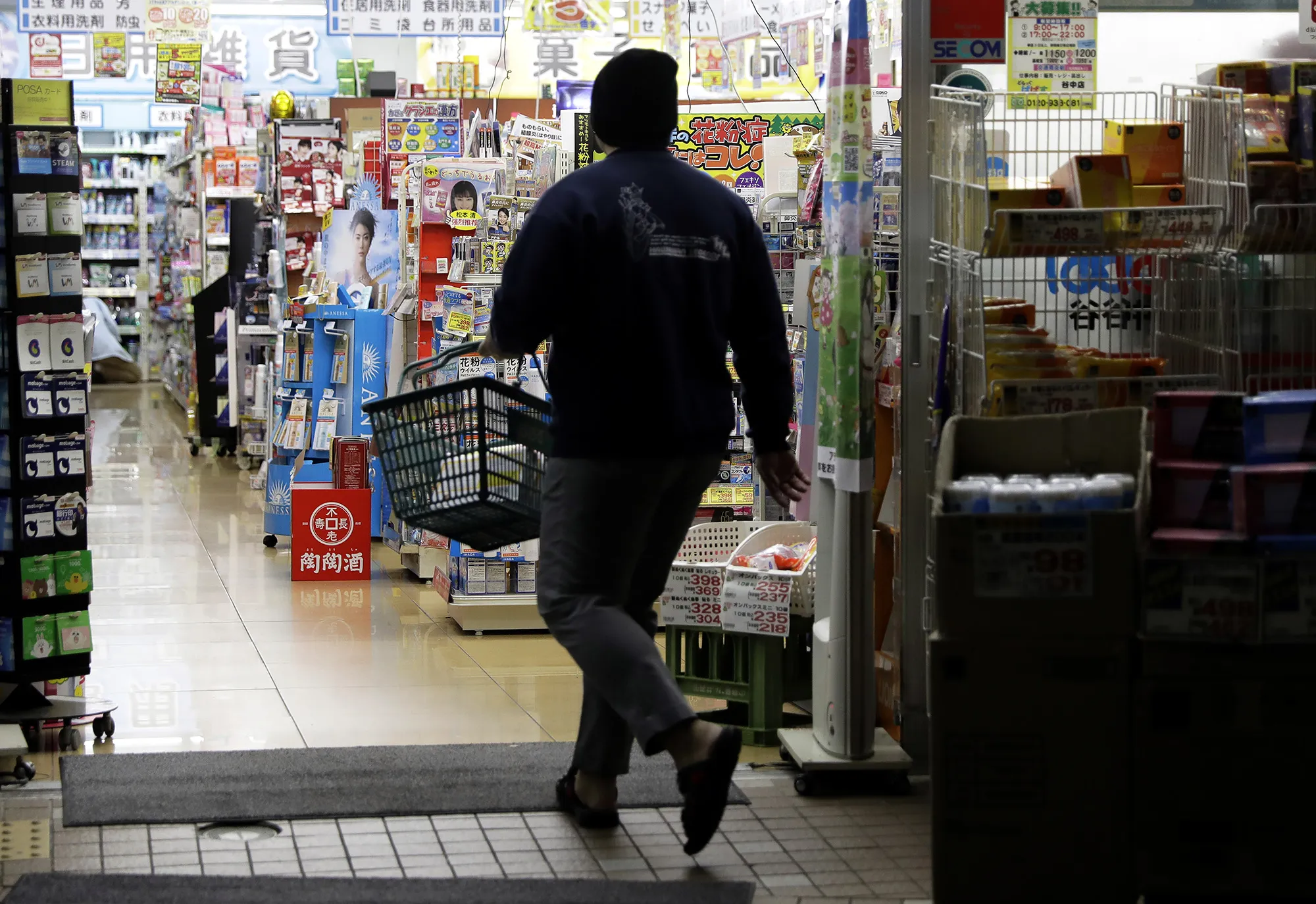A shopper enters a drugstore in&nbsp;the Yanesen district of Tokyo.