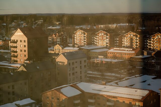 View of town buildings through a window curtain