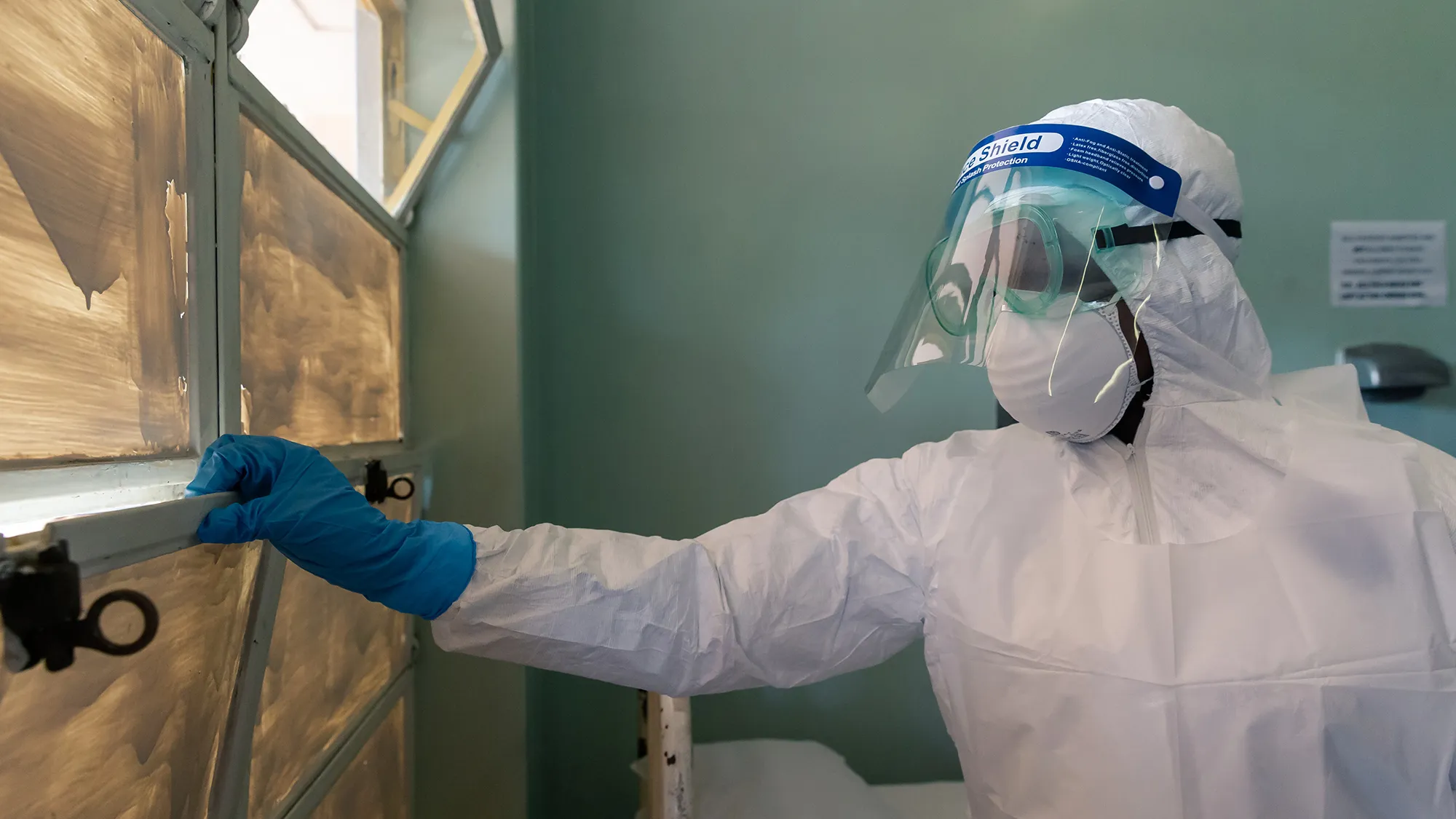 A medical staff member wears a protective suit at the Wilkins Infectious Diseases Hospital in Harare on March 11.