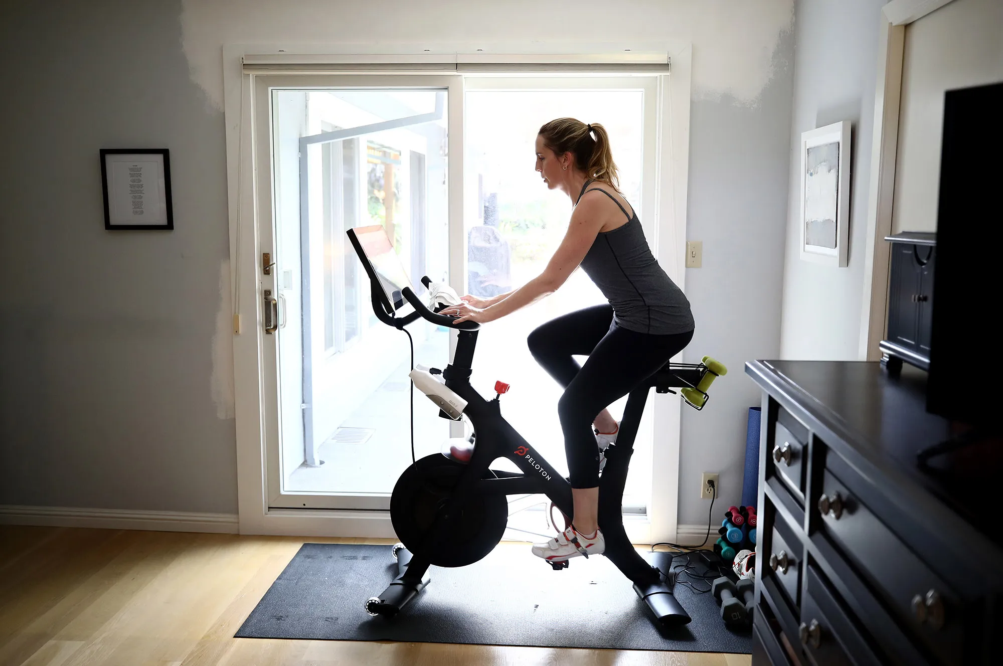 A Peloton customer in California rides her bike in April 2020.