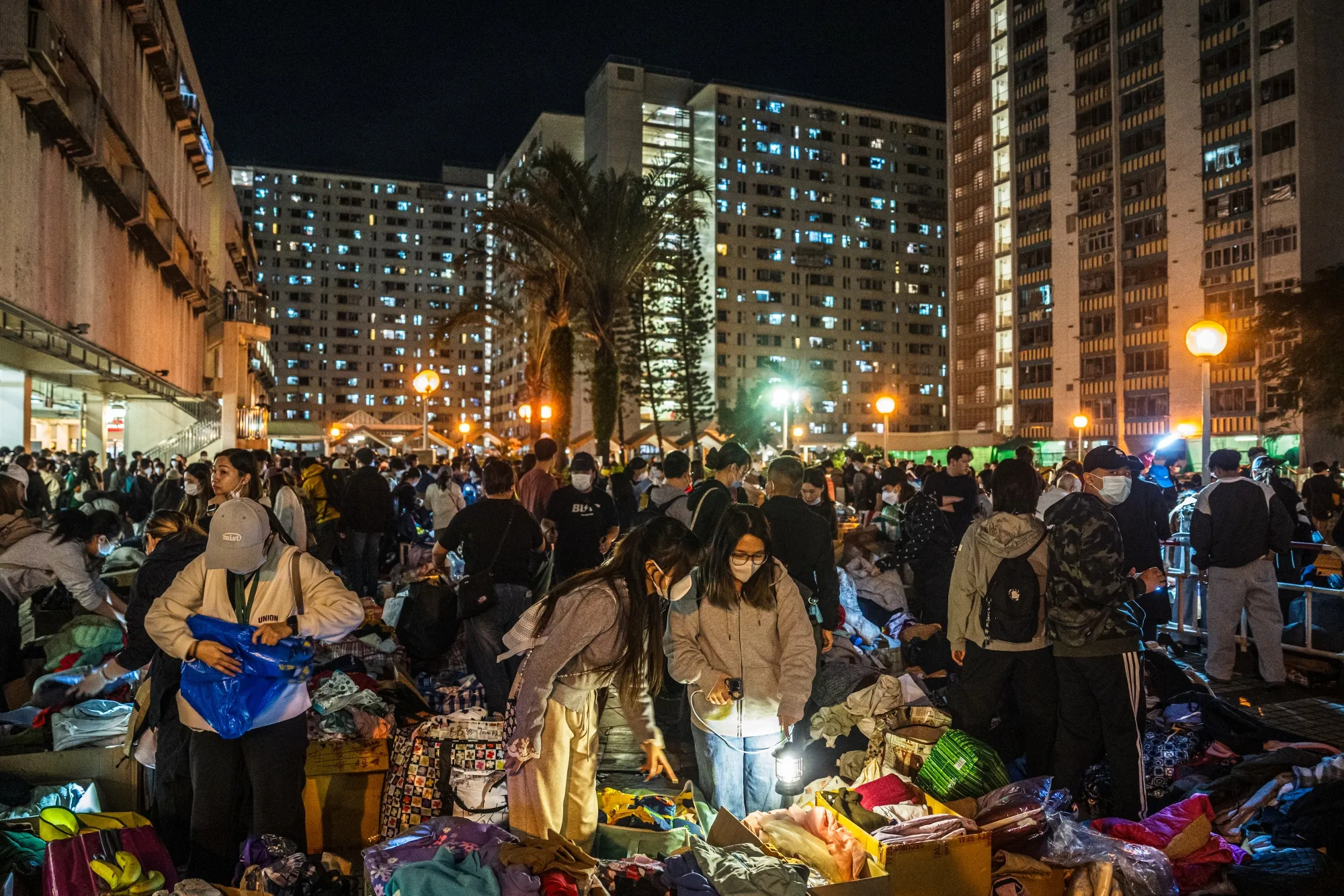 Volunteers distribute supplies for residents displaced by the fire at Wang Fuk Court.
