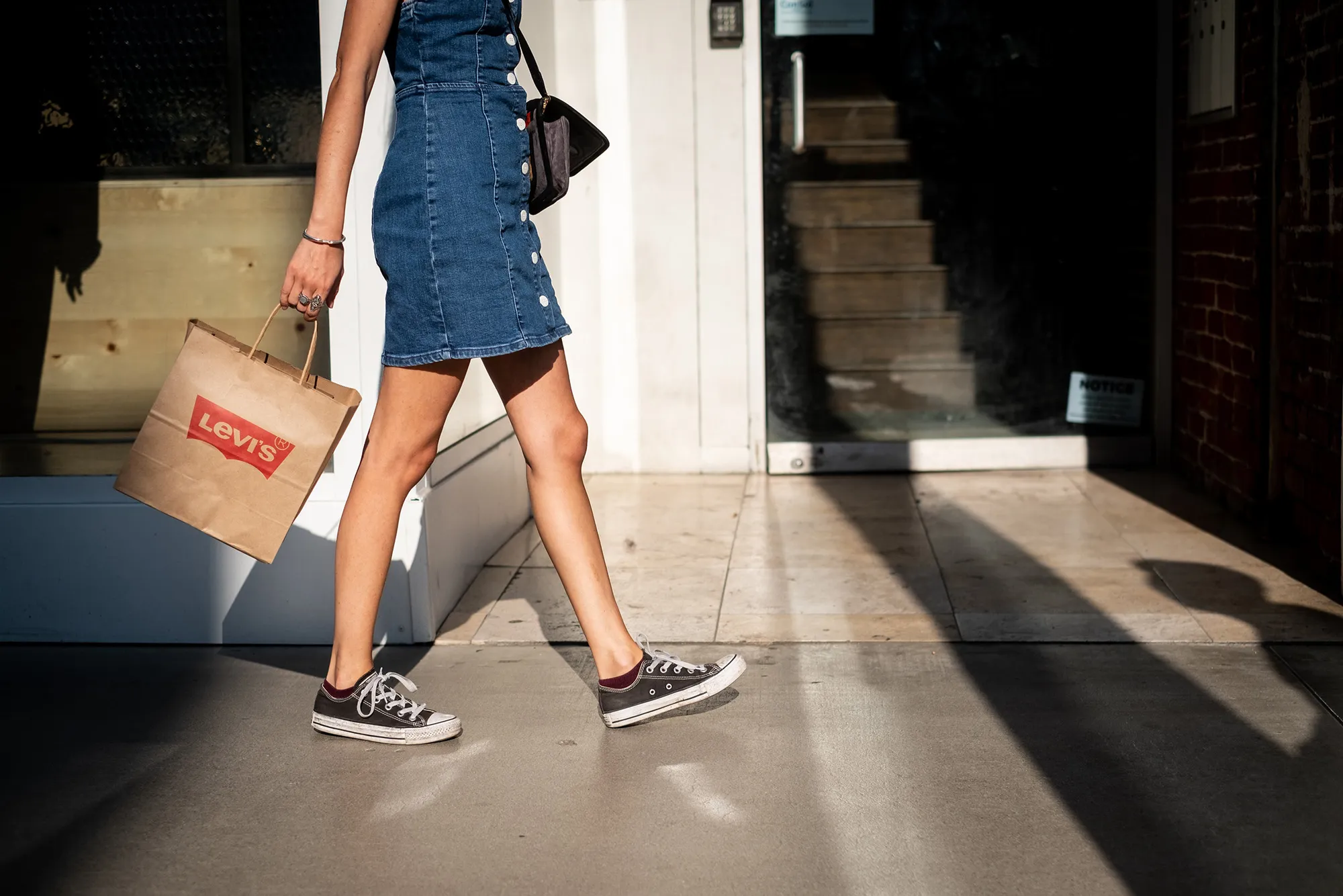 A shopper carries a Levi Strauss & Co. bag on the Third Street Promenade in Santa Monica, California.