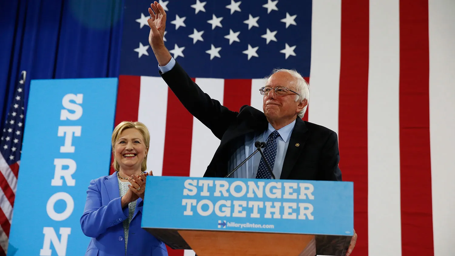 Senator Bernie Sanders waves as he and Democratic presidential candidate Hillary Clinton arrive for a rally in Portsmouth, New Hampshire, on July 12, 2016.
