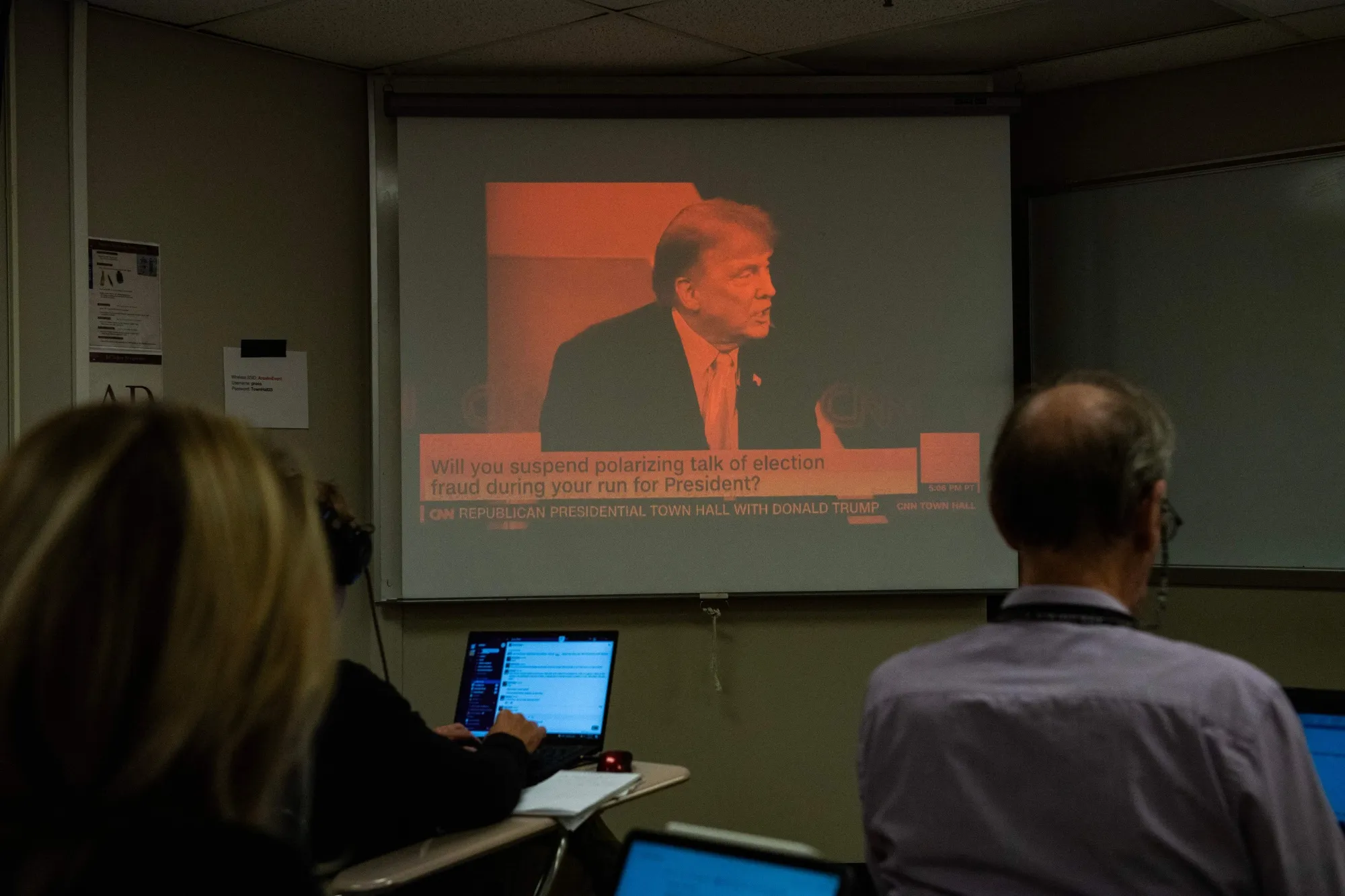 Reporters watch a CNN town hall with Donald Trump on May 10.