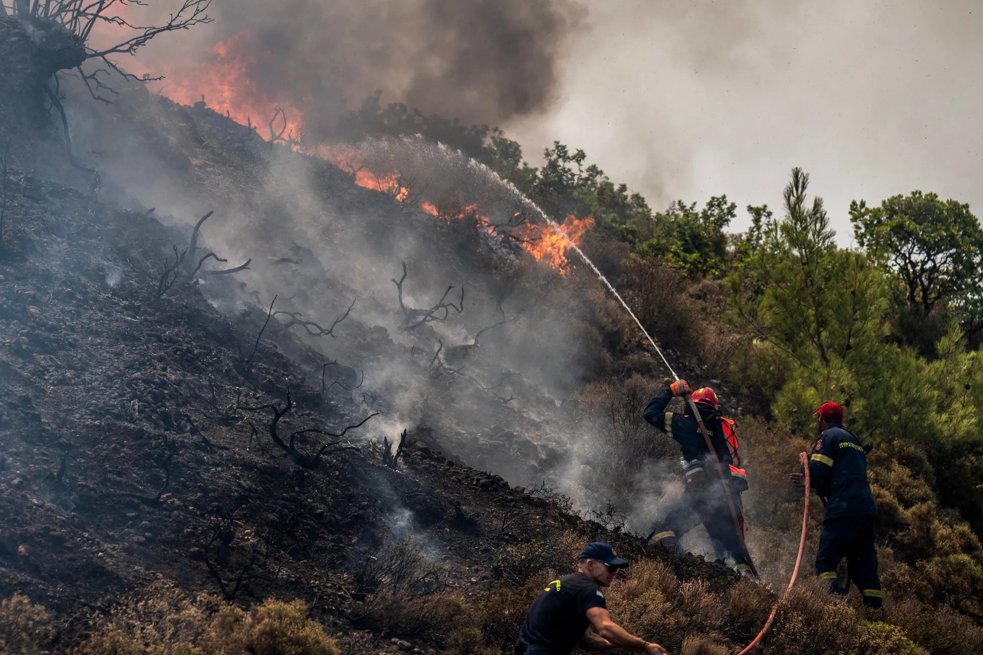 Firefighters tackle wildfires near Vati on the island of Rhodes, Greece on July 26.