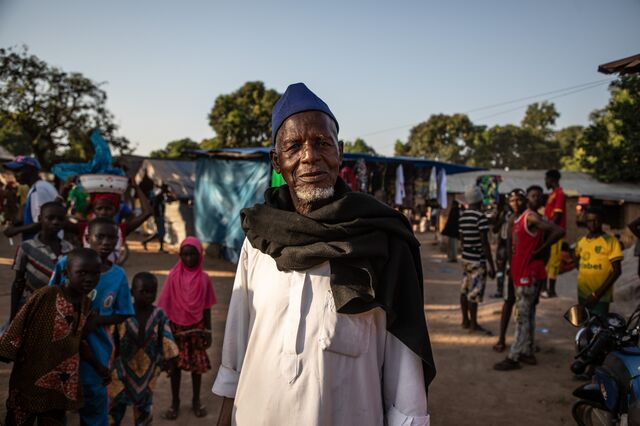 Abdoulaye Bangoura, chief of Sékousoryah district, amid buildings cracked by dynamiting for a nearby railway tunnel.