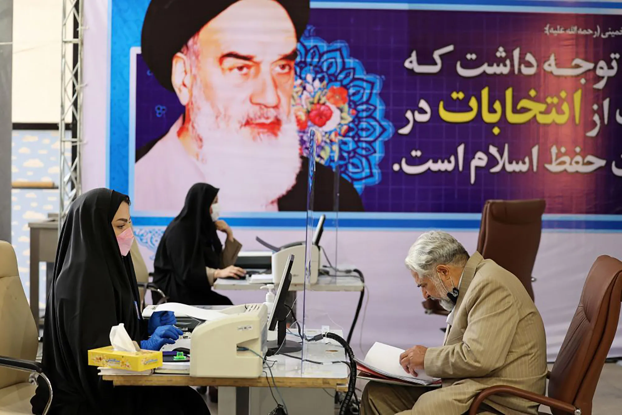 A&nbsp;man registers his candidacy for the presidential elections at the Interior Ministry with Ayatollah Ali Khamenei seen in the background, in Tehran on May 11.&nbsp;