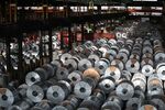 Steel coils sit in a storage area ahead of shipping at a steel plant in Salzgitter, Germany.