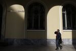 A pedestrian passes Piraeus Bank SA bank branch in Thessaloniki, Greece, on Thursday, Dec. 1, 2016. Greek markets have rallied this month on expectations creditors may finally ease the country’s debt at a Dec. 5 meeting of euro-area finance ministers.