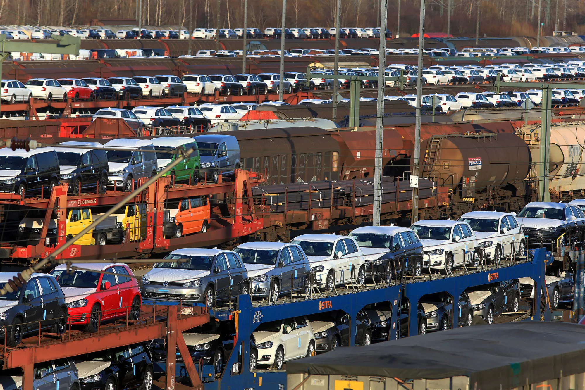 New automobiles, manufactured by Volkswagen AG, sit on railway transporters in Munich.
