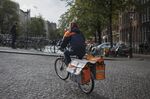 A postal worker for PostNL delivers mail in Amsterdam.