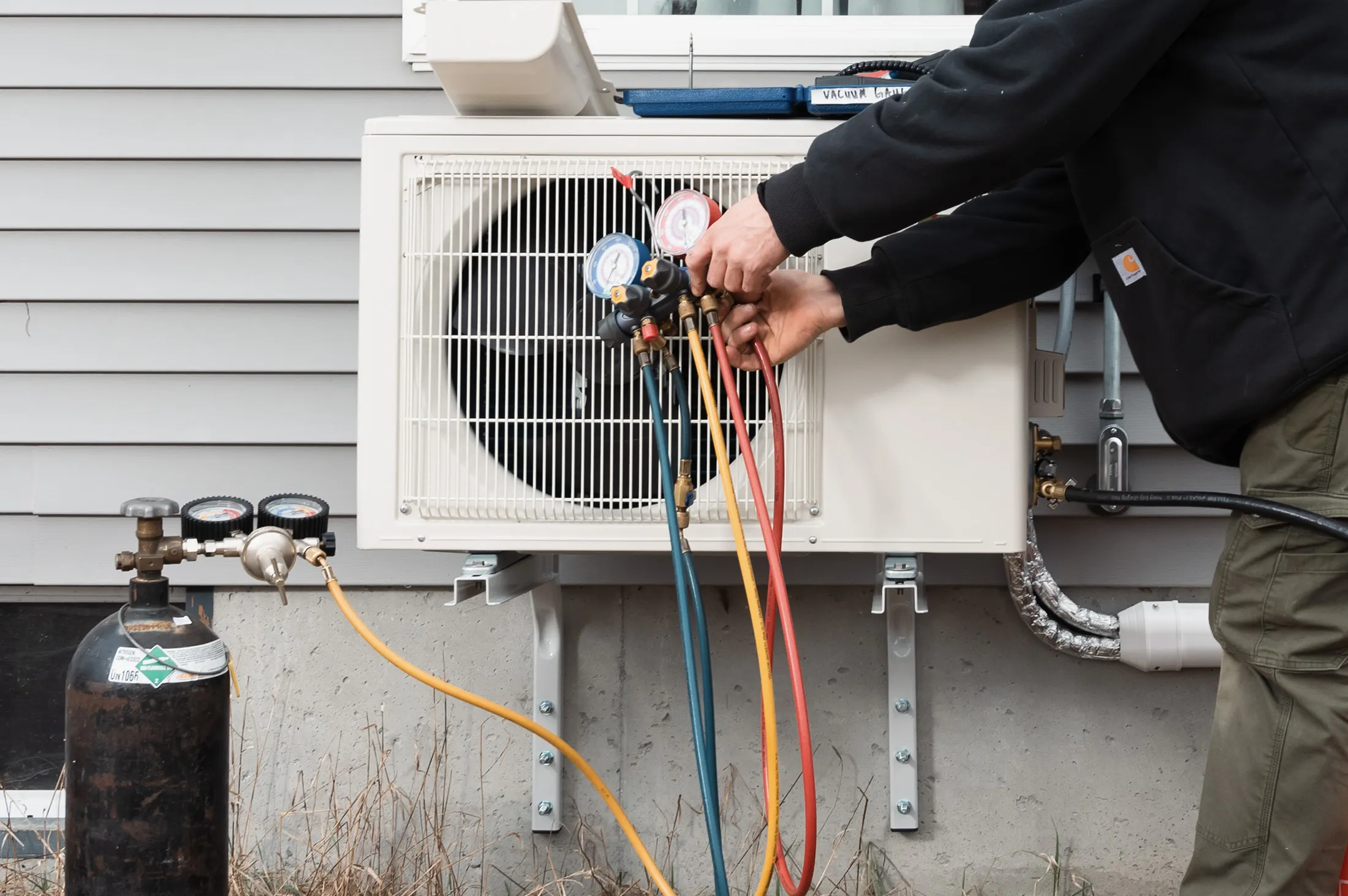 A technician installs an electric heat pump.
