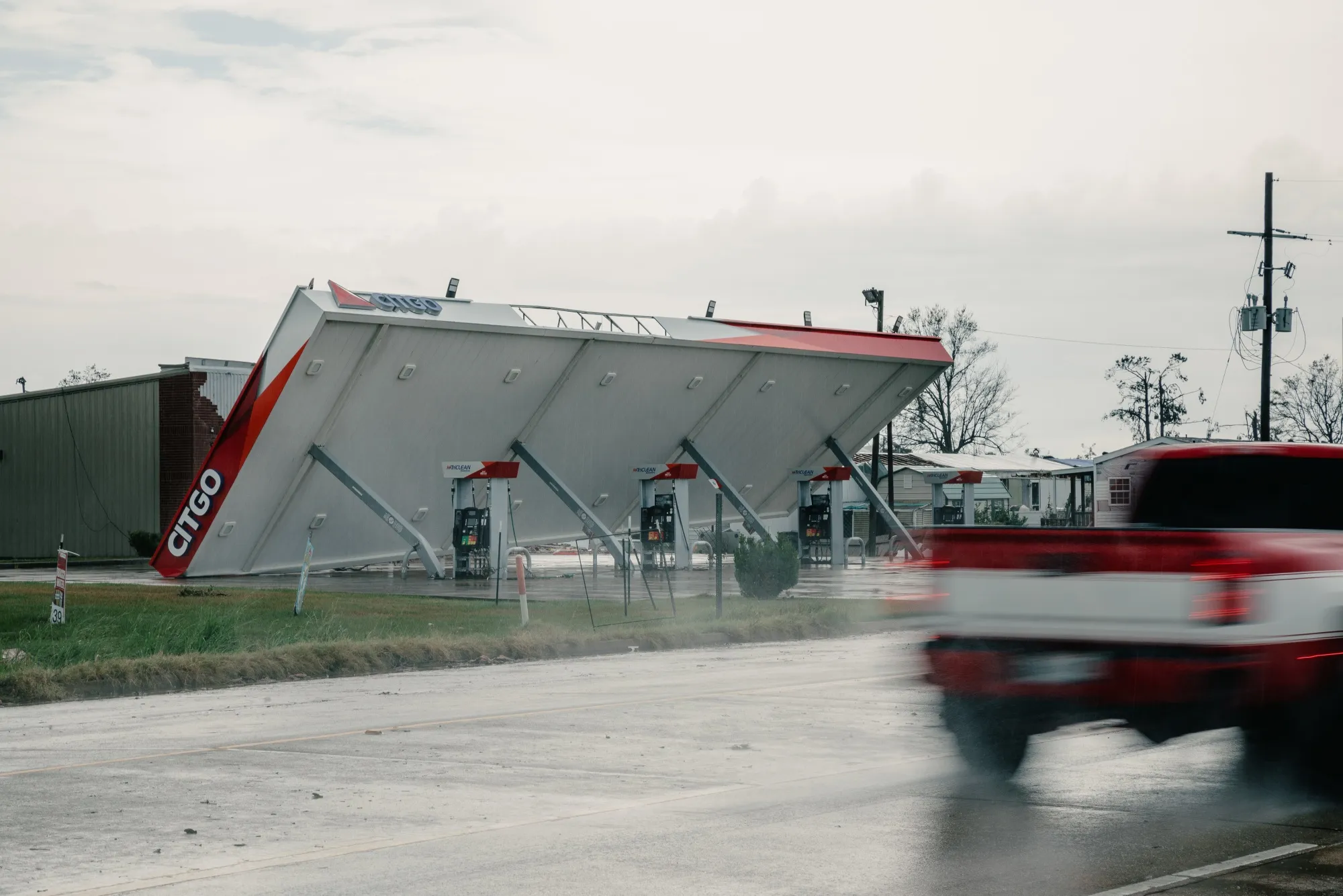 A truck drives past a damaged Citgo gas station in Lake Charles, Louisiana, after Hurricane Laura made landfall.