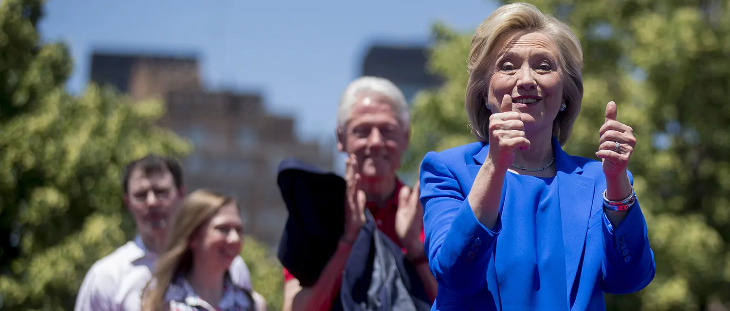 Hillary Clinton, former secretary of state and 2016 Democratic presidential candidate, right, gestures towards supporters after speaking at her first campaign rally at Four Freedoms Park with husband, Bill Clinton, former U.S. President, second from right, daughter Chelsea Clinton, and Marc Mezvinsky, husband of Chelsea Clinton, on Roosevelt Island in New York, U.S., on Saturday, June 13, 2015. Clinton launched the second phase of her presidential campaign today, drawing heavily on her personal story as she outlined her vision for shared prosperity for all Americans.
