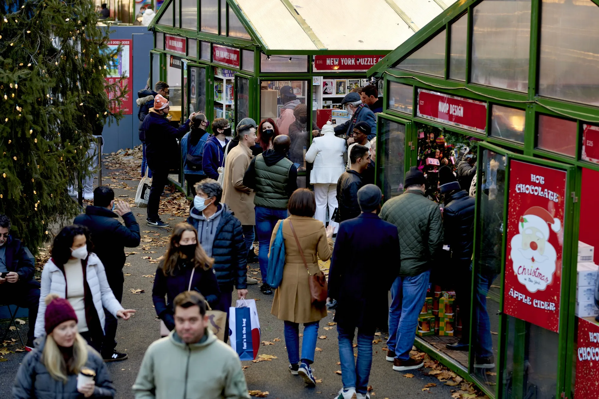 Shoppers walk through the Urbanspace Holiday Shops at Bryant Park in New York.