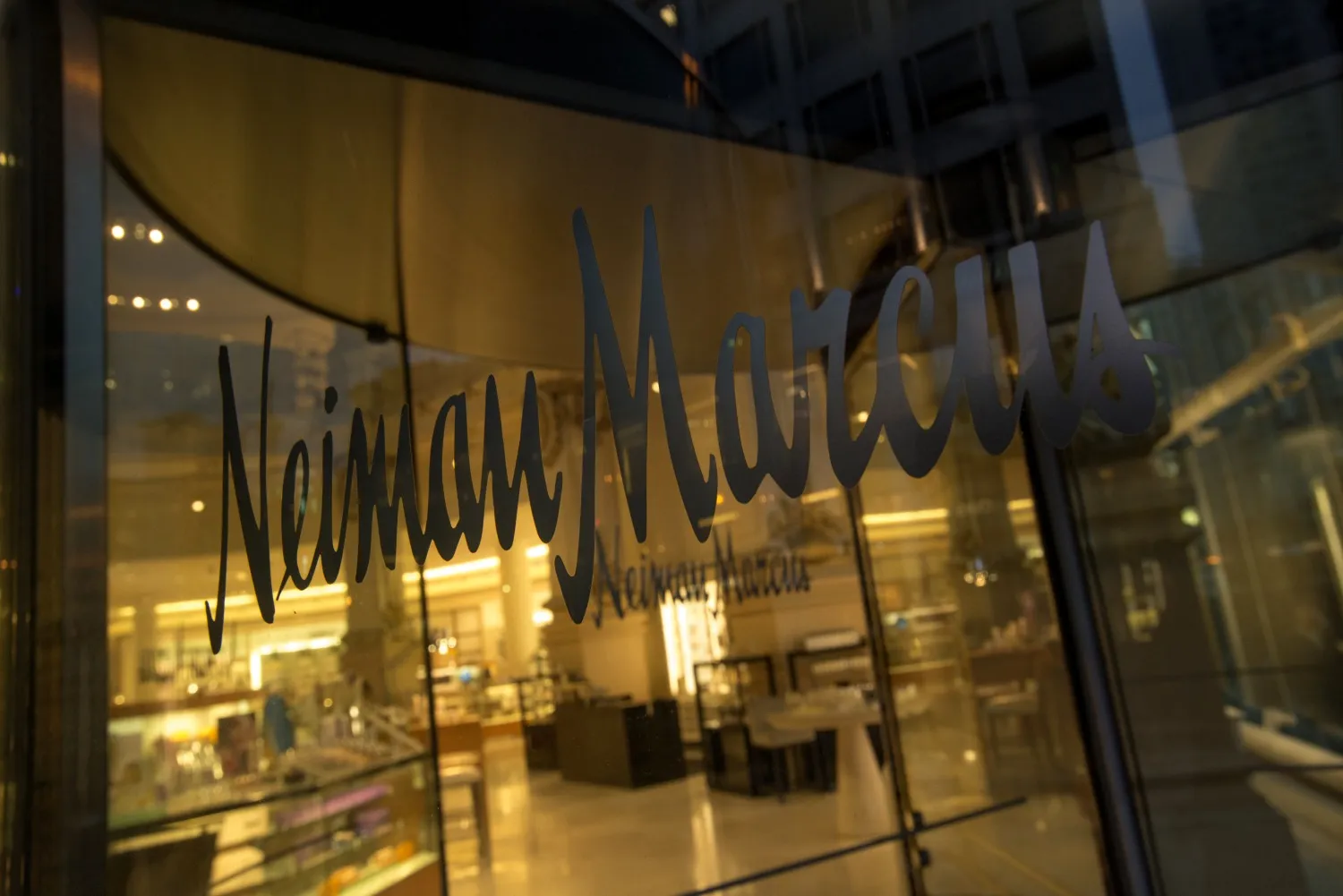 Neiman Marcus Inc. signage is displayed on the window of a store in San Francisco.