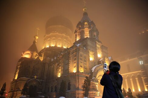 A woman take photos of the Saint Sophia Cathedral in Harbin on Nov. 10, 2015
