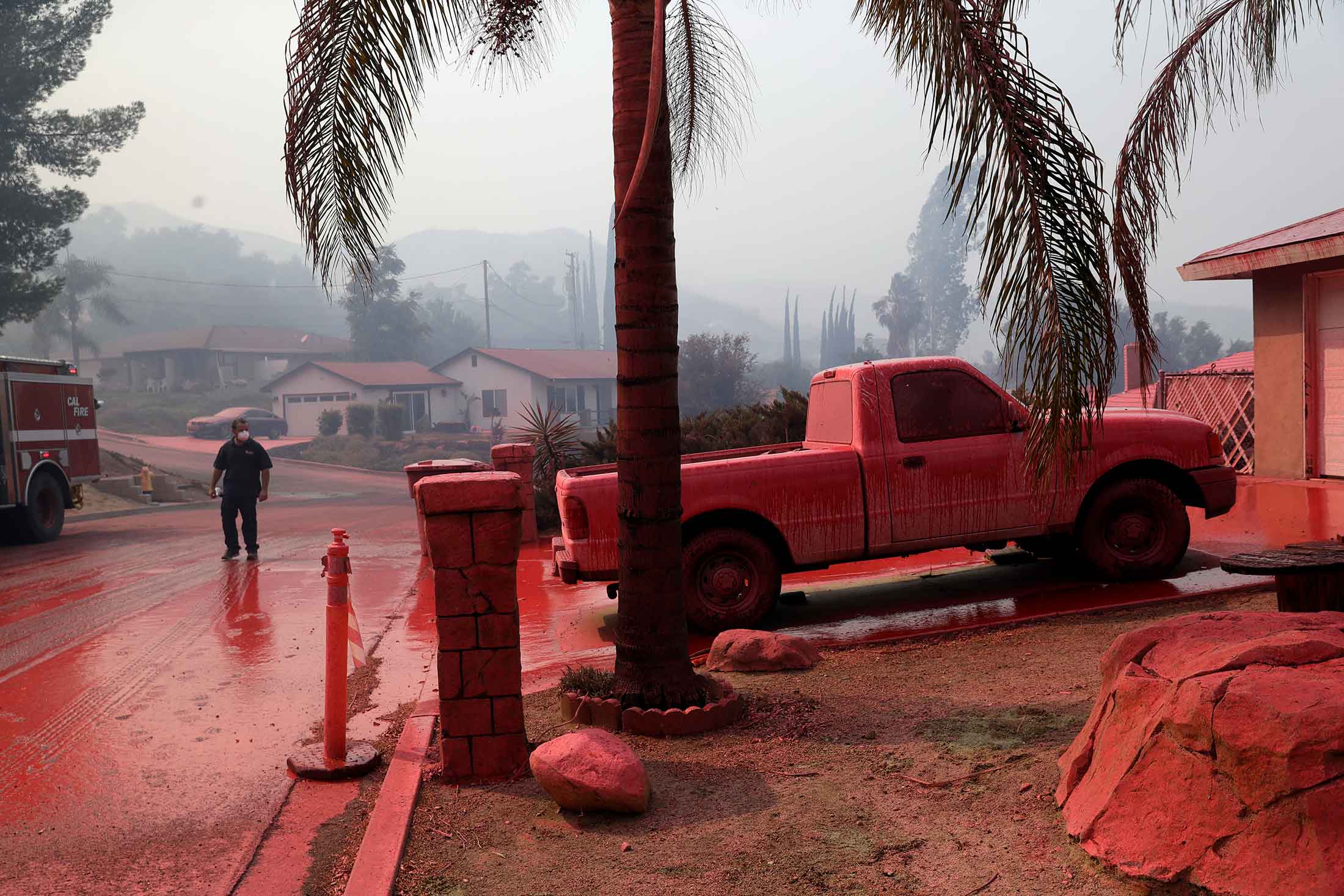 A neighborhood in Lake Elsinore, Calif., covered in fire retardant dropped by an air tanker.