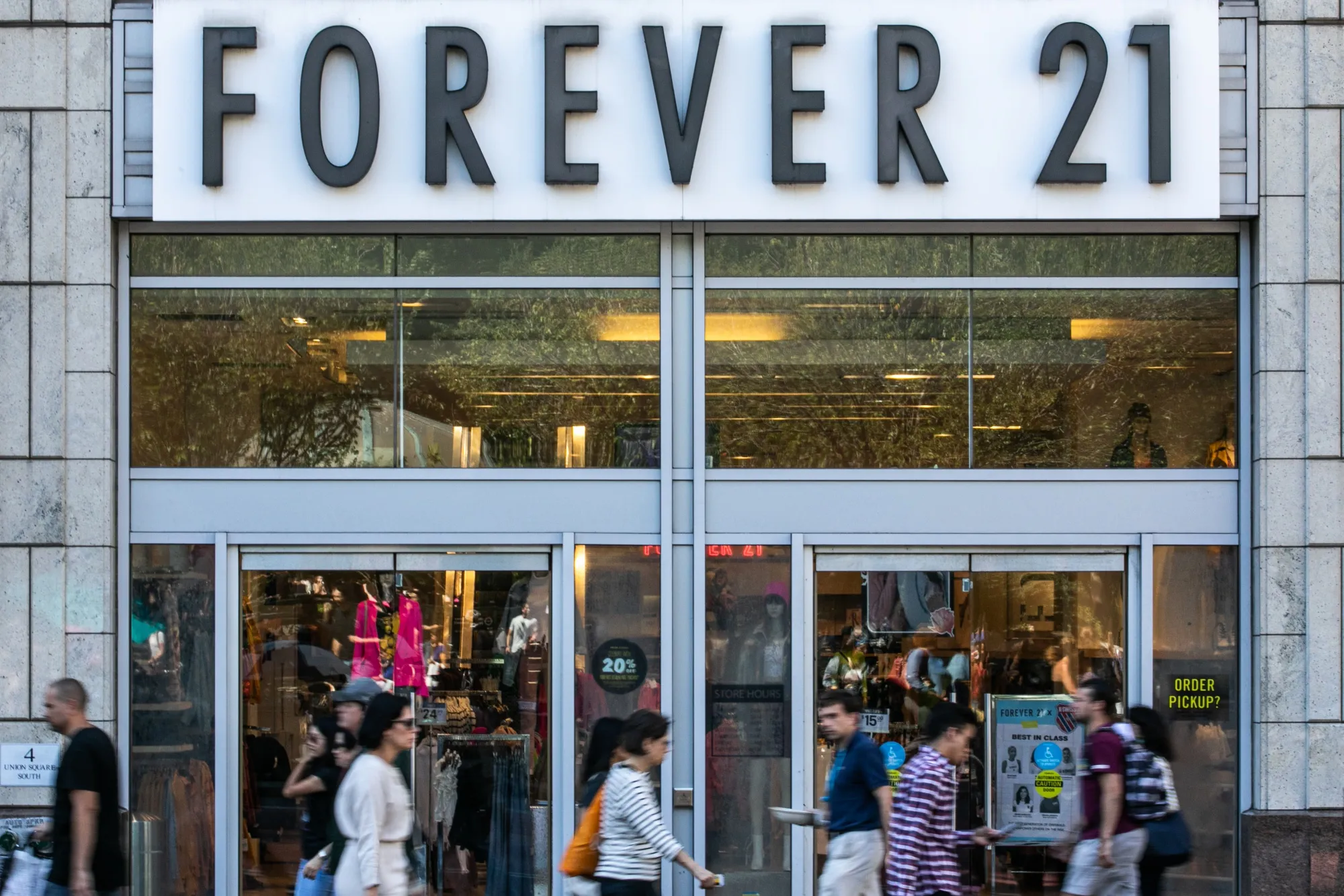 Pedestrians pass in front of a Forever 21 Inc. store in the Union Square neighborhood of New York, U.S., on Thursday, Aug. 29, 2019. Forever 21 Inc. is preparing for a potential bankruptcy filing as the fashion retailers cash dwindles and turnaround options fade, according to people with knowledge of the plans.