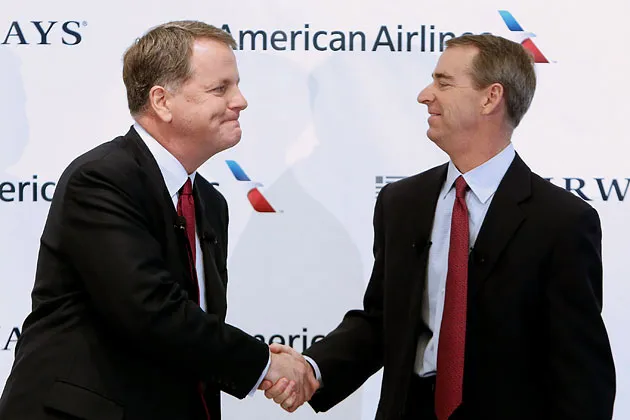 Doug Parker (left), CEO of US Airways, shakes hands with Tom Horton, president and CEO of AMR’s American Airlines, during a press conference at Dallas/Fort Worth International Airport on Feb. 14