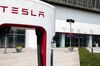 The Tesla Inc. logo is displayed outside one of the company's showrooms in Beijing, China, on Friday, May 10, 2019. Beijing has vowed to retaliate after U.S. President Donald Trump followed through with his threat to raise tariffs Friday on $200 billion of Chinese imports to 25% from 10% percent.