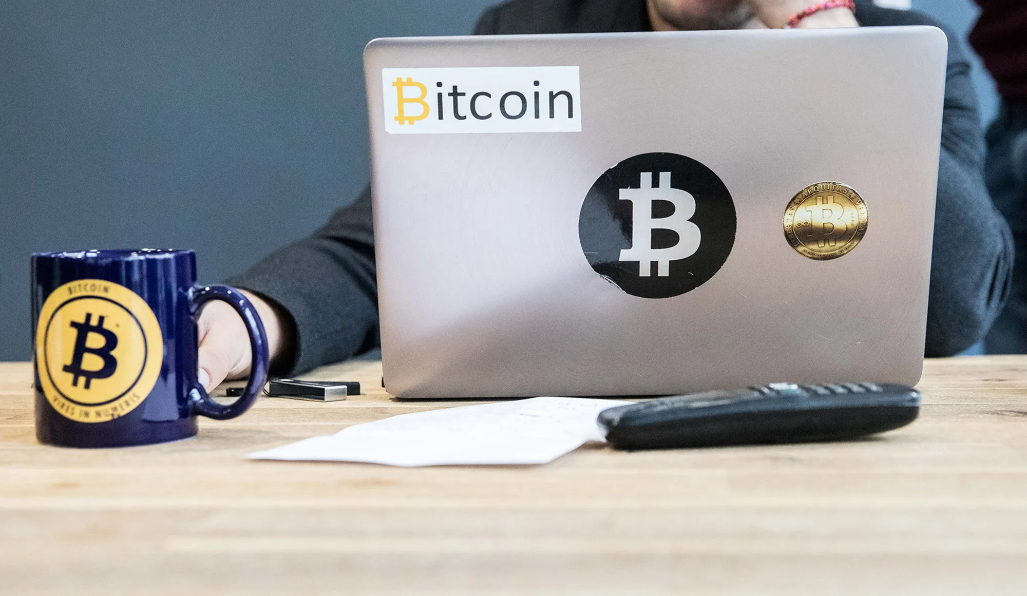 An employee uses a laptop computer branded with bitcoin logos inside the offices of La Maison du Bitcoin bank in Paris, France.