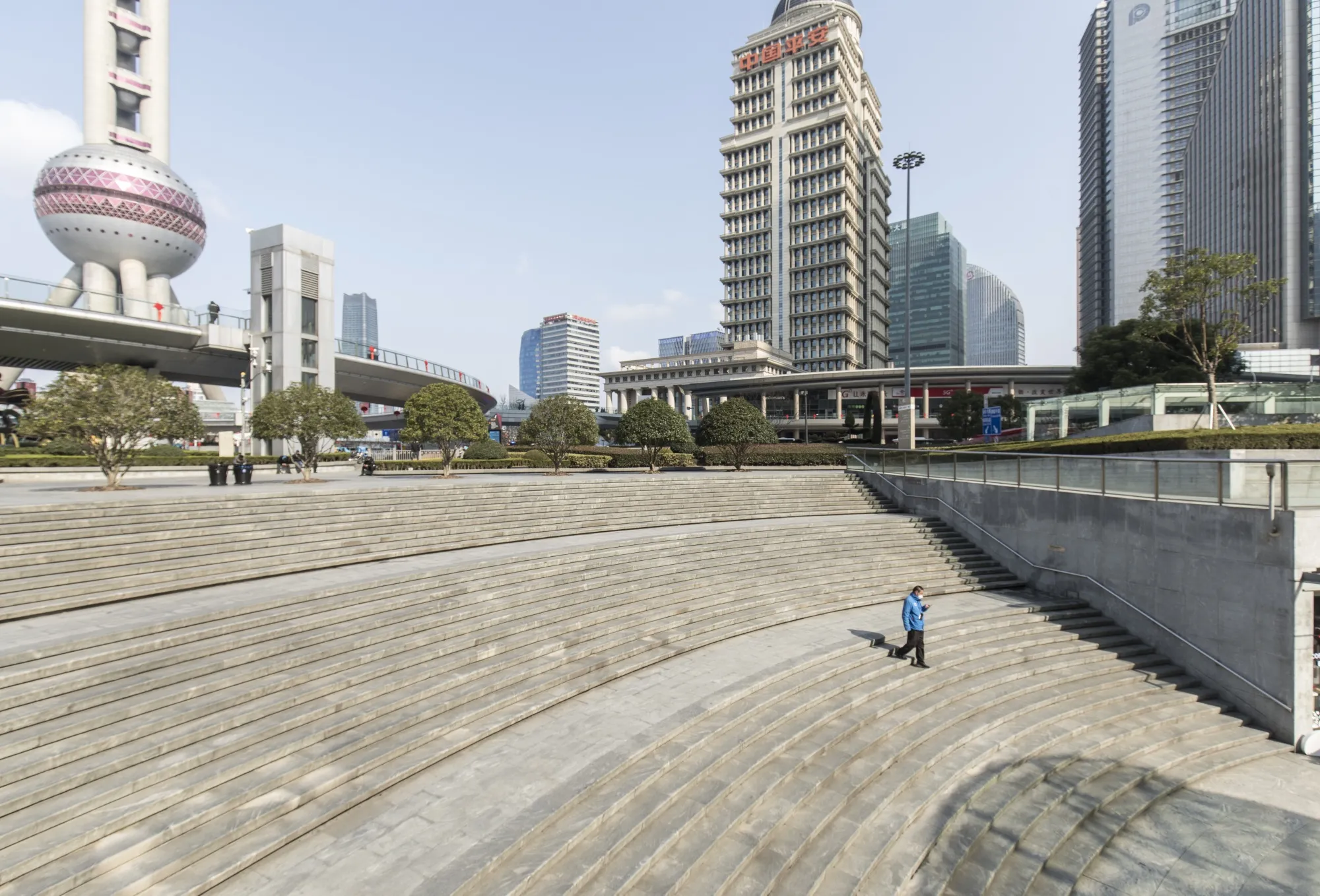 A courier walks down a staircase to a shopping plaza in the Lujiazui Financial District in Shanghai on Feb. 5.