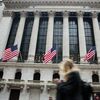 American flags fly as a pedestrian walks past the New York Stock Exchange (NYSE) in New York, U.S., on Friday, Feb. 23, 2018. U.S. stocks rose with Treasuries and the dollar slipped as investors await clues on Federal Reserve policy intentions under new Chairman Jerome Powell.