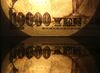 A Japanese 10,000 yen banknote is reflected in a table surface in an arranged photograph in Tokyo, Japan.