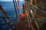 An employee walks down stairs on a gas condensate platform in the North Sea, off the coast of Aberdeen, UK.