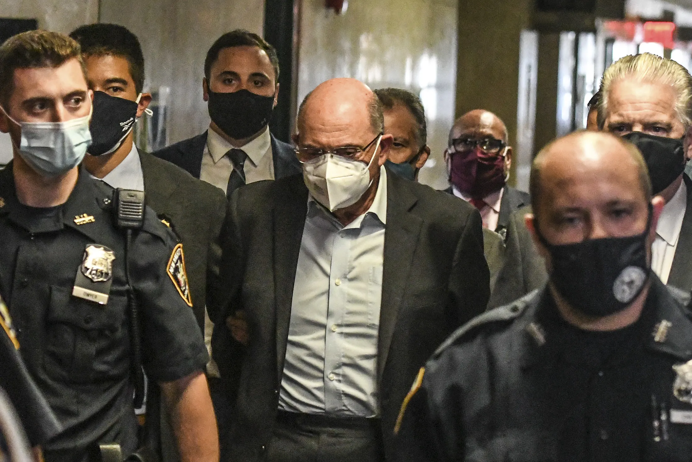 Allen Weisselberg, center, walks towards a courtroom at criminal court in New York, on July 1.