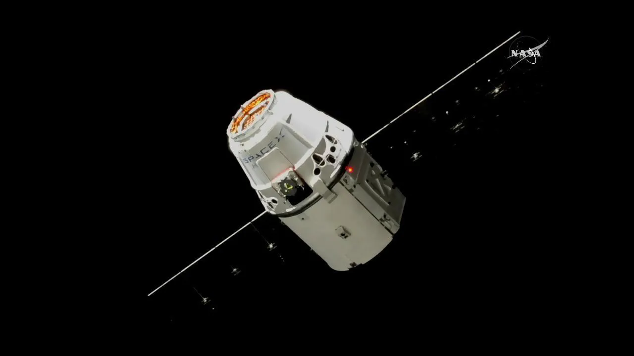 The SpaceX Dragon capsule approaches the International Space Station.